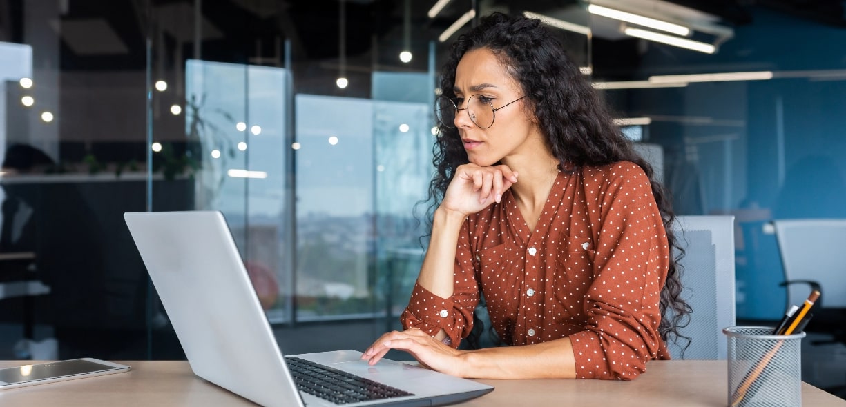 Woman staring at computer in office