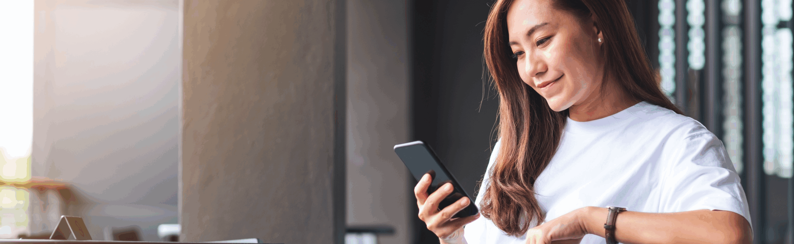 Woman smiling looking at cellphone